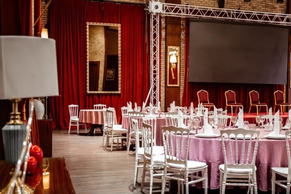 classic restaurant witn red curtains and stage